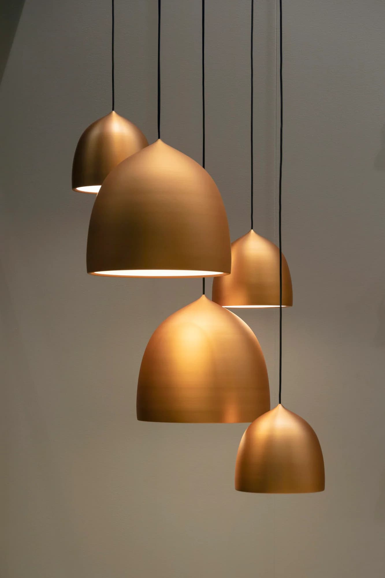 Three brass bell pendant lights hanging