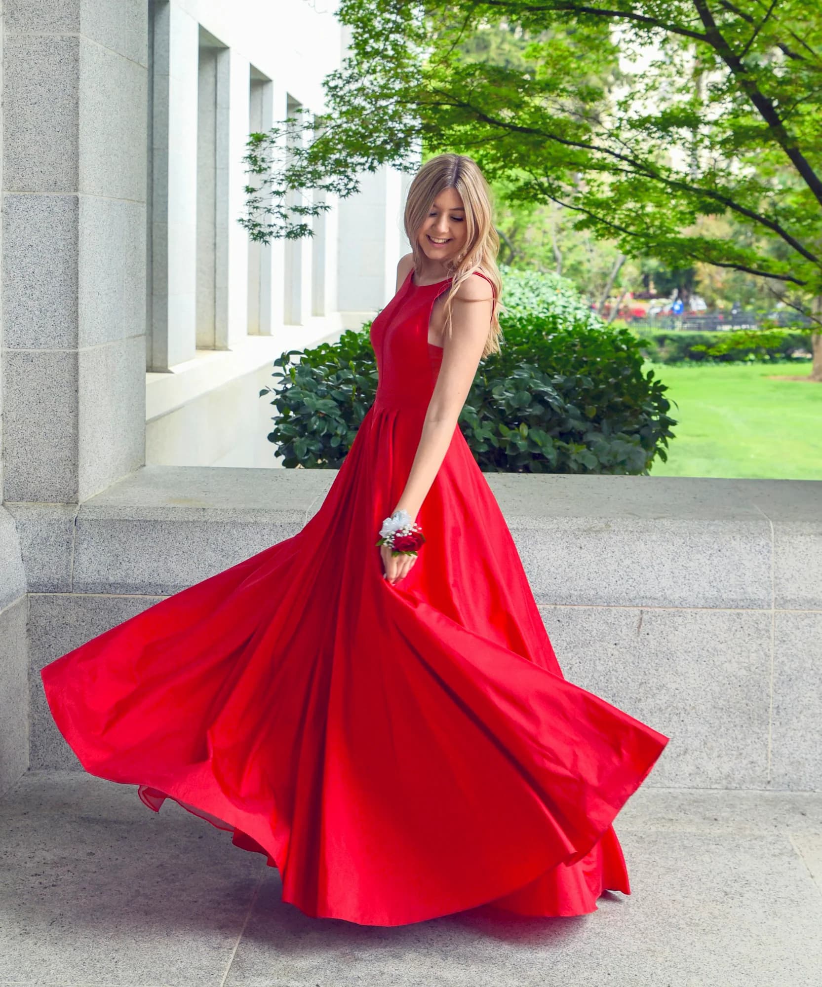 Woman in a flowing red silk gown outdoors